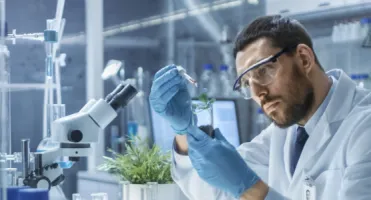 researcher in a laboratory looking at a sample